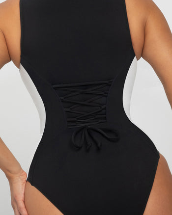 Model wears Crewy Surfy Shapewear One Piece Swimsuit - Contour Black/White back view close up