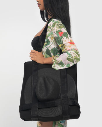 Model is posing with Totey Waterproof Spacious Bag with Hat Holder - Black side view