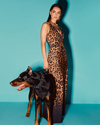 Model wears Brazilian Plungey Cheeky One Piece Shapewear Swimsuit - Symmetric Leopard and a matching skirt
