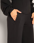 Model showing hand in zipper pocket on the Cloudlined Wide Leg Pant - Soft Black
