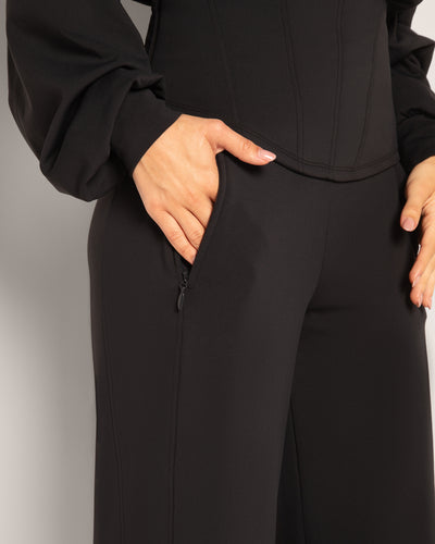 Model showing hand in zipper pocket on the Cloudlined Wide Leg Pant - Soft Black