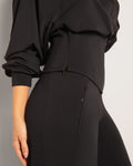 Side view image of Cloudlined Corset Hoodie and Cloudlined Wide Leg Pant - Soft Black to show the zipper closure on hoodie and zipper pocket on pant