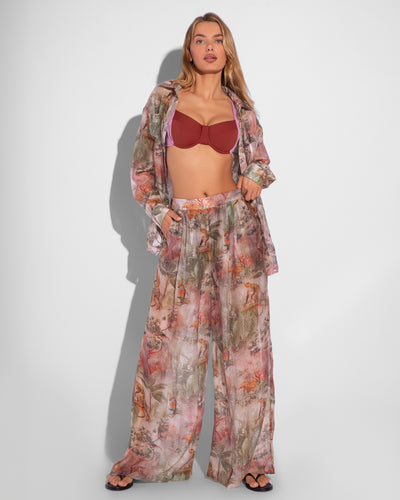 Model is posing in Flowy Pull On Wide Leg Pant - Soft Tropical and matching print long sleeve unbuttoned shirt front view