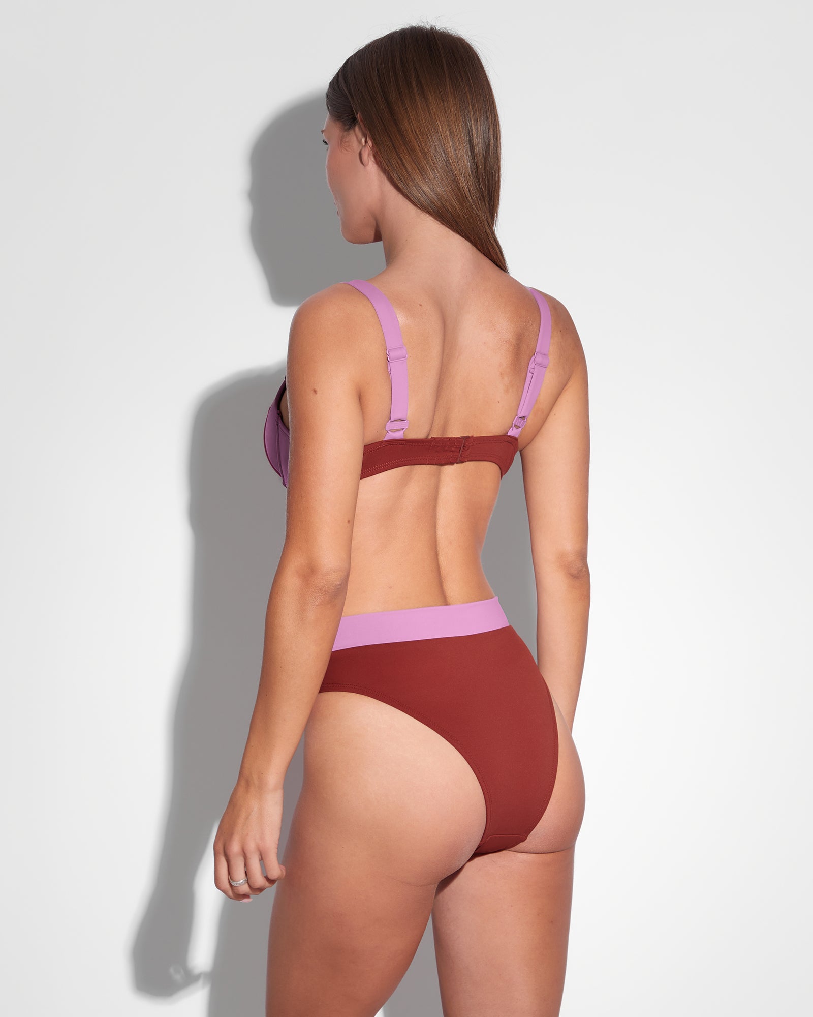 Model wears Brazilian Ring Kini Bottom - Copper/Lilac Two Piece Shapewear back view