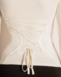 Model wears Shapey Ruched Long Sleeve Shapewear Top - Eggshell back view