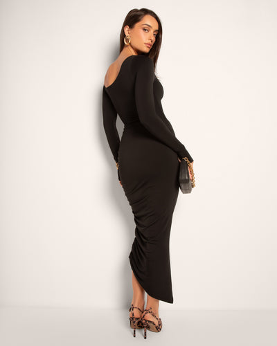 Model wears Sculpty One Shoulder Long Sleeve Shapewear Top - Black and a skirt side view