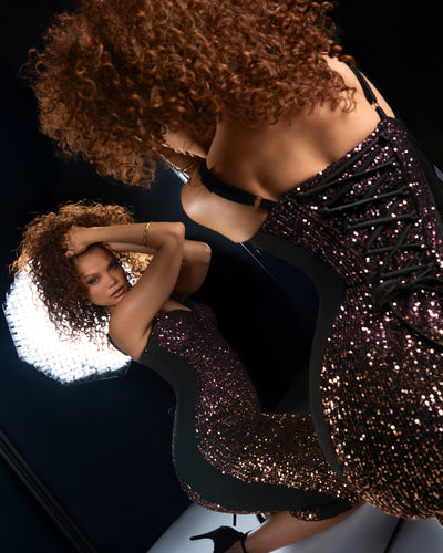 Model in Seamed Lushy Midi Dress - Sequin Ombre Bronze/Plum looking in the mirror 