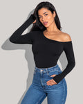 Model is posing in Shapey Long Sleeve One Shoulder Sculpting Shapewear Top - Black side view top is tucked in