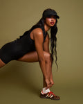 Model is posing in Sleeveless Surfy Shortie Sculpting Shapewear Swimsuit - Black side view