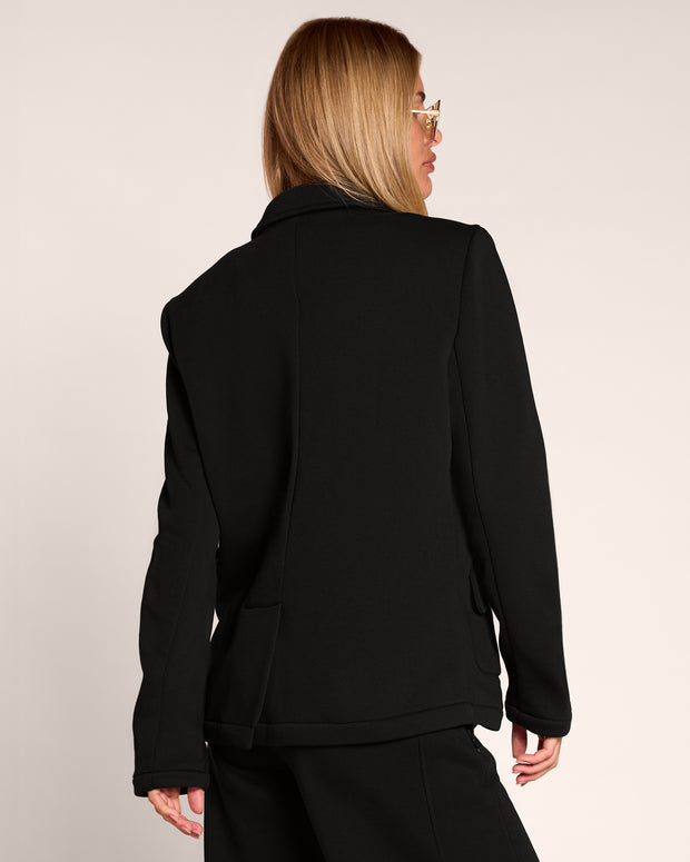 Back view of model wearing Swuity Convertible Jacket - Black as a blazer