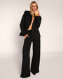 Full body front view of model wearing Fleecey Wide Leg Pull On Pant - Black paired with the Swuity Convertible Jacket - Black