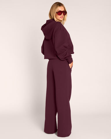 Full body back view of model wearing Convertible Fleecey - Garnet
