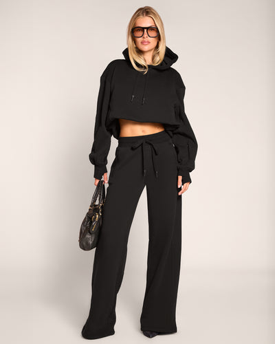 Full body front view of model wearing Fleecey Wide Leg Pull On Pant - Black paired with Convertible Fleecey - Black