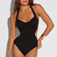 Model is posing in one piece swimsuit