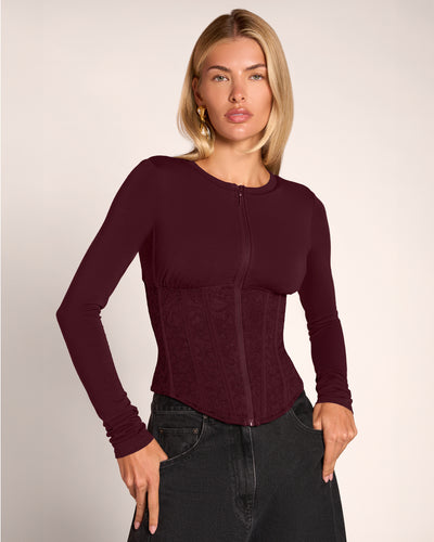 Model wearing Corsety Long Sleeve Top - Lace Garnet/Garnet zipped up front view