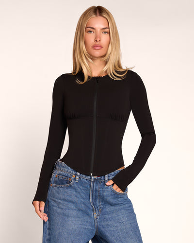 Model in Corsety Long Sleeve Top - Black front view zipped up