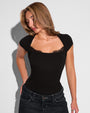 Model wearing Shapey Ruched Short Sleeve Top - Black tucked into denim pants