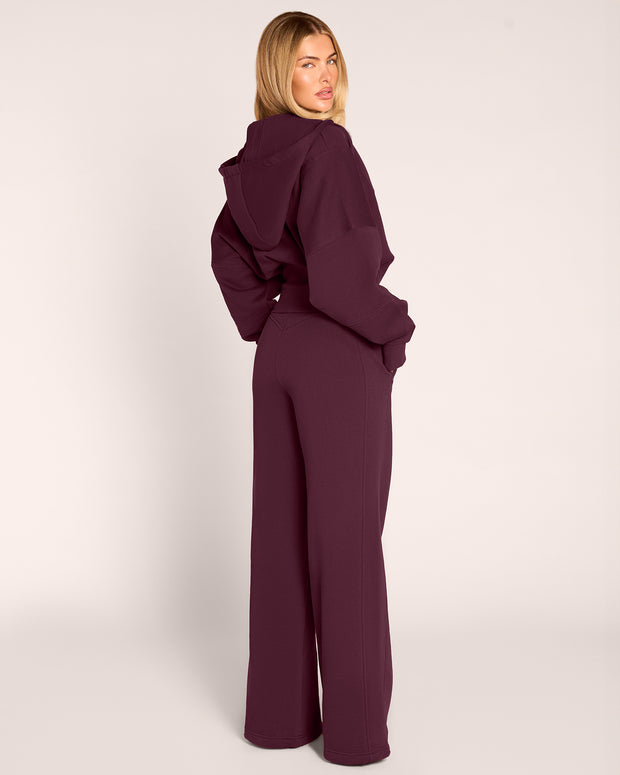 Full body back view of model wearing Croissant Fleecey - Garnet
