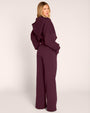 Full body back view of model wearing Croissant Fleecey - Garnet