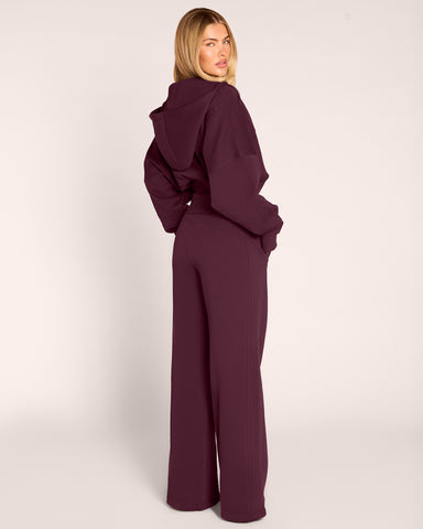 Full body back view of model wearing Croissant Fleecey - Garnet